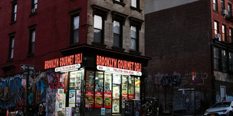 people walking on sidewalk near store during daytime